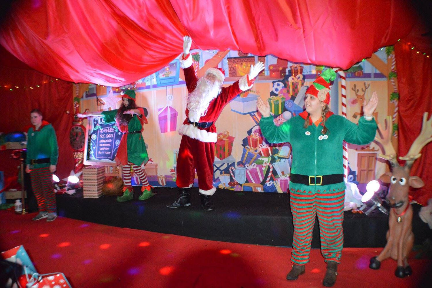 Santa clause and his elves dancing in his grotto